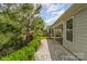 A backyard view featuring a paved walkway, patio, and lush landscaping at 8210 Festival Way, Charlotte, NC 28215