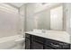 Bathroom with a white vanity, dark cabinets, and a large mirror above the sink at 8210 Festival Way, Charlotte, NC 28215