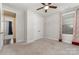 Inviting bedroom featuring a ceiling fan, double closet, and a window with curtains at 8210 Festival Way, Charlotte, NC 28215