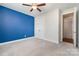 Bedroom with a bold blue accent wall and a double closet with a ceiling fan at 8210 Festival Way, Charlotte, NC 28215