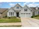 Beautifully landscaped home with a well-manicured lawn and a charming facade at 8210 Festival Way, Charlotte, NC 28215