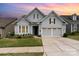 Charming two-story home featuring a two-car garage, landscaped yard, and inviting front entrance at 8210 Festival Way, Charlotte, NC 28215