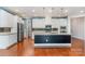 Stylish kitchen features white cabinetry, stainless steel appliances, granite countertops and a dark kitchen island at 8210 Festival Way, Charlotte, NC 28215