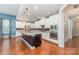 Light-filled kitchen featuring stainless appliances, granite counters, white cabinets, and a dark island at 8210 Festival Way, Charlotte, NC 28215