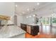 Bright, open kitchen features granite countertops, an island with stainless steel appliances, and hardwood flooring at 8210 Festival Way, Charlotte, NC 28215