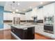 Spacious kitchen with stainless steel appliances, granite counters, ample cabinet space, and large island at 8210 Festival Way, Charlotte, NC 28215