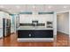 Charming kitchen featuring white cabinets, granite countertops, stainless appliances, and black island at 8210 Festival Way, Charlotte, NC 28215