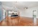 Open floor plan showcasing hardwood floors, a kitchen island, and ample living space at 8210 Festival Way, Charlotte, NC 28215