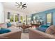 Bright living room featuring a ceiling fan, neutral furniture, area rug, and a dining table with seating at 8210 Festival Way, Charlotte, NC 28215