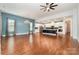 Open-concept living room boasts hardwood floors, large windows, and a view into the stylish, modern kitchen at 8210 Festival Way, Charlotte, NC 28215