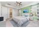 Well-lit main bedroom with white bed furnishings, blue accents, and a private bathroom with white cabinets at 8210 Festival Way, Charlotte, NC 28215
