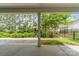 View of the patio and landscaped backyard with green space and black metal fencing at 8210 Festival Way, Charlotte, NC 28215