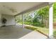 Covered patio with ceiling fan offers an excellent view of the manicured lawn and garden at 8210 Festival Way, Charlotte, NC 28215