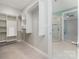 Well-organized walk-in closet adjacent to a bathroom with a glass shower stall at 8210 Festival Way, Charlotte, NC 28215