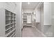 Spacious walk-in closet with ample shelving and hanging storage for organization at 8210 Festival Way, Charlotte, NC 28215