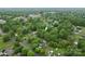 A high aerial view shows the home nestled in a residential area surrounded by lush green trees at 93 34Th Street Nw Ct, Hickory, NC 28601
