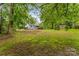 Backyard has a spacious lawn, wooded perimeter and a covered parking area at 93 34Th Street Nw Ct, Hickory, NC 28601