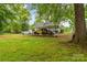 Backyard features a covered parking area and lush trees at 93 34Th Street Nw Ct, Hickory, NC 28601