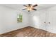 Bright bedroom features wood-look flooring, a ceiling fan, and a window for natural light at 93 34Th Street Nw Ct, Hickory, NC 28601