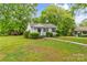 Inviting one-story home with a covered porch and lush green lawn, perfect for outdoor enjoyment at 93 34Th Street Nw Ct, Hickory, NC 28601
