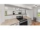Modern kitchen featuring stainless steel appliances and an open layout to the living area at 93 34Th Street Nw Ct, Hickory, NC 28601