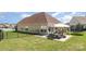 Spacious backyard with a patio dining set, and trampoline, surrounded by lush green grass at 9588 Marquette Nw St, Concord, NC 28027