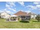 Expansive backyard featuring a patio, trampoline, and well-maintained lawn, perfect for outdoor activities at 9588 Marquette Nw St, Concord, NC 28027