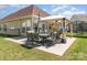 Inviting backyard featuring an outdoor dining area and covered patio, perfect for entertaining at 9588 Marquette Nw St, Concord, NC 28027