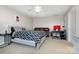 Cozy bedroom features a comfortable bed, brown leather couch, and a desk with a personal computer at 9588 Marquette Nw St, Concord, NC 28027