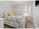Comfortable bedroom featuring a bed with yellow pillows, light window coverings, and neutral carpeting at 9588 Marquette Nw St, Concord, NC 28027