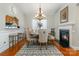 Elegant dining room with a chandelier, a fireplace, and a bar pass-through to the kitchen at 9588 Marquette Nw St, Concord, NC 28027