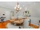 Elegant dining room with a chandelier, a table, and a bar pass-through to the kitchen at 9588 Marquette Nw St, Concord, NC 28027