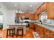 Bright kitchen features stainless steel appliances, hardwood floors, and a breakfast bar with stool seating at 9588 Marquette Nw St, Concord, NC 28027