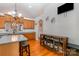 Bright eat-in kitchen boasts wood floors, island, breakfast bar, wood cabinets and stainless steel appliances at 9588 Marquette Nw St, Concord, NC 28027