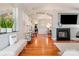 Spacious living room with a fireplace, hardwood floors, and views of the dining room and hallway at 9588 Marquette Nw St, Concord, NC 28027