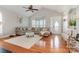 Bright living room features vaulted ceilings, hardwood floors, a plush sectional couch, and a neutral palette at 9588 Marquette Nw St, Concord, NC 28027