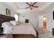 Spacious main bedroom features ceiling fan, tray ceiling, neutral decor and ensuite access at 9588 Marquette Nw St, Concord, NC 28027