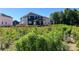 A lush green backyard behind a two-story home featuring a covered patio at 1001 Cunningham Farm Dr, Indian Trail, NC 28079