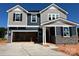 Two-story home with gray and blue siding, stone accents, and an attached two-car garage at 1001 Cunningham Farm Dr, Indian Trail, NC 28079