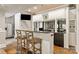 Finished basement bar area with countertop, cabinetry and stools at 1001 Medinah Ct, Waxhaw, NC 28173