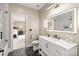 Elegant bathroom with white marble vanity, large illuminated mirror, and walk-in shower at 1001 Medinah Ct, Waxhaw, NC 28173