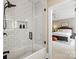 Modern tub/shower combo with subway tile surround, glass door, and black hardware at 1001 Medinah Ct, Waxhaw, NC 28173