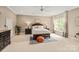 Spacious bedroom featuring a king-size bed, large window, and neutral decor at 1001 Medinah Ct, Waxhaw, NC 28173