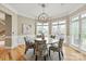 Elegant dining room featuring hardwood floors, large windows, and a modern chandelier at 1001 Medinah Ct, Waxhaw, NC 28173