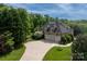 Stunning two-story brick home with a three-car garage and a well-manicured lawn at 1001 Medinah Ct, Waxhaw, NC 28173