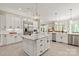 Bright kitchen with stainless steel appliances, a center island with seating, and elegant pendant lighting at 1001 Medinah Ct, Waxhaw, NC 28173
