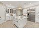 Gourmet kitchen featuring an island with marble countertop, stainless steel refrigerator, and custom cabinetry at 1001 Medinah Ct, Waxhaw, NC 28173