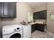 Functional laundry room equipped with modern appliances, ample counter space, and plenty of storage cabinets at 1001 Medinah Ct, Waxhaw, NC 28173