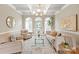 Bright living room featuring coffered ceilings, neutral tones, and large windows for natural light at 1001 Medinah Ct, Waxhaw, NC 28173