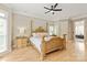 This primary bedroom is filled with natural light and includes a luxurious four-poster bed and side tables at 1001 Medinah Ct, Waxhaw, NC 28173
